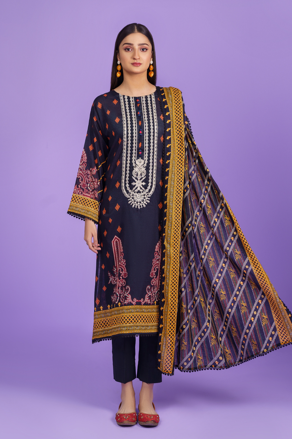 a woman wearing an Ittehad dark grey embroidered suit and dupatta.